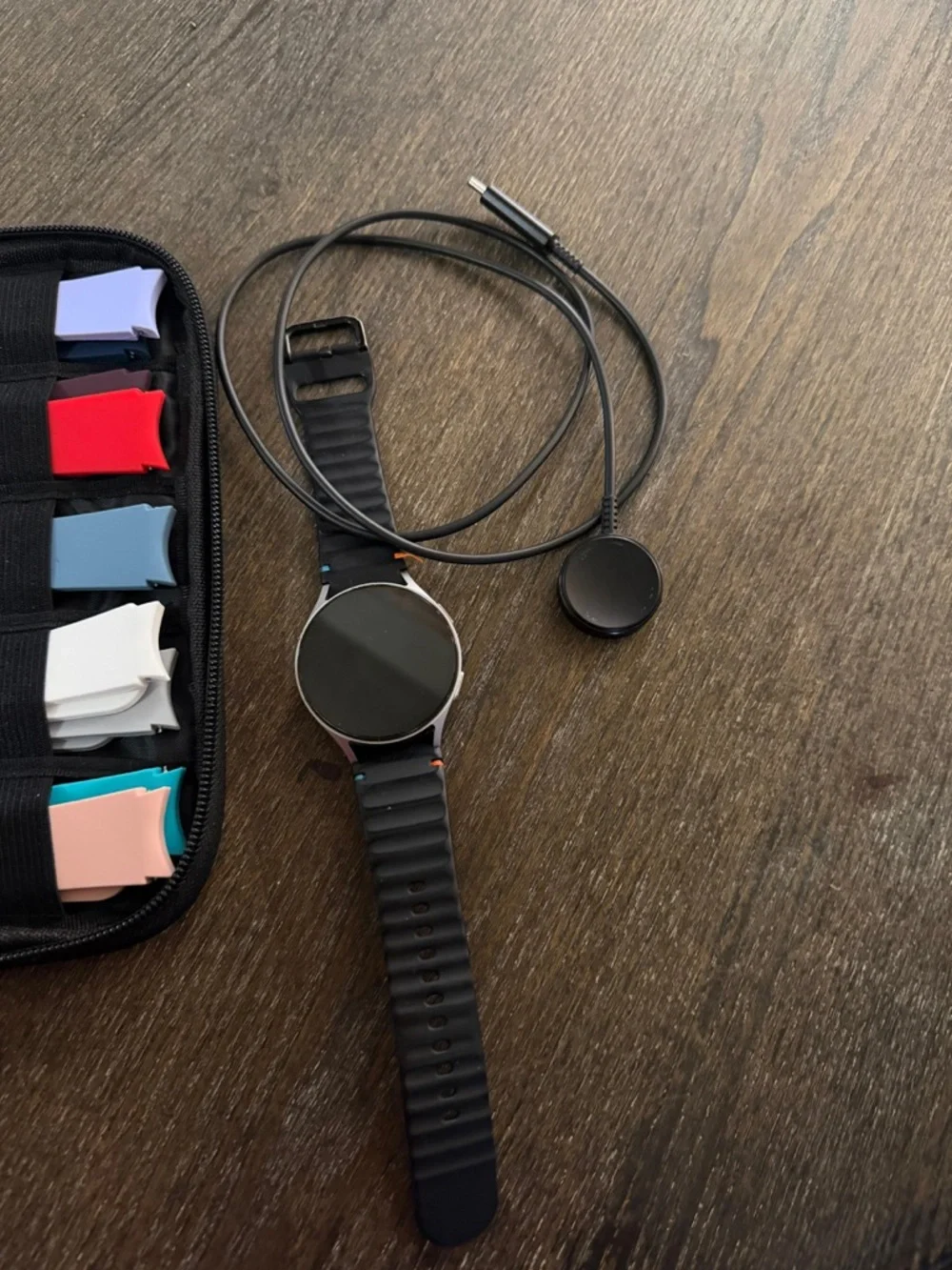 Samsung smartwatch with multiple colorful silicone bands